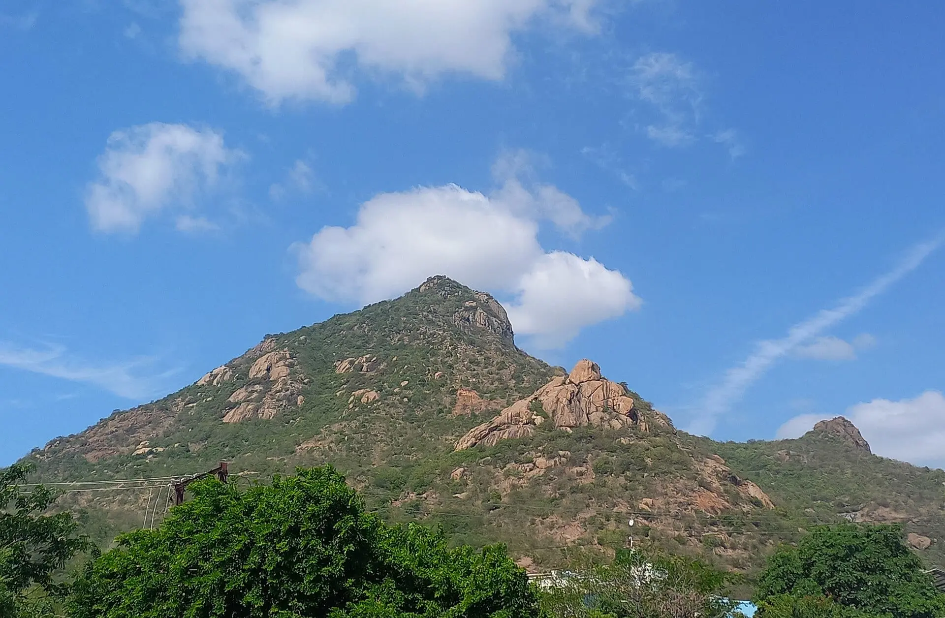 Arunachala hill under white clouds, seen from the Anna Arch junction in Tiruvannamalai